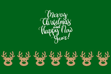 Wooden Christmas toys head of a deer is lined with a pattern on a green background. Add text Merry Christmas and Happy New Year. Minimalistic style. Flat lay, top view