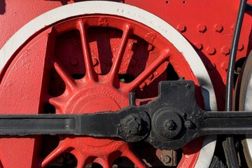Metal red wheel of an old railway transport (steam locomotive)