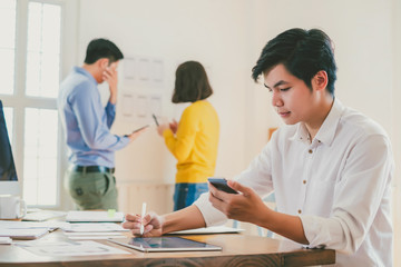 Creative planning and working mobile application design team in the office.