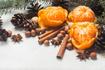 Mandarins, Christmas tree branches, spices, cinnamon, cones on a white stone background. Concept of Christmas, New Year, Mulled Wine, Winter, Holidays