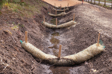 The use of straw wattles. Land drainage works. - obrazy, fototapety, plakaty