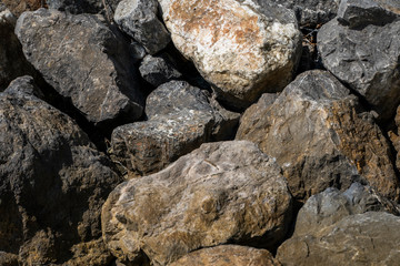 Fototapeta na wymiar Big rocks on a beach in a sunlight.