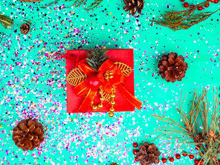 Red gift box in trendy mint green colors tones. Flat lay background. Festive concept. Selective...