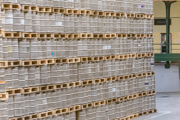 Beer barrels. Beer factory. Beer warehouse. Racks of beer barrels on pallets.