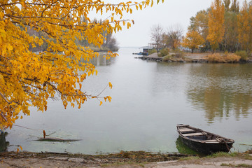 Azov City and Don River Scenery autumn landscape with yellow tree,   water and wooden boat