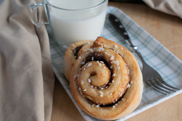 cinnamon rolls with glass of milk on the table