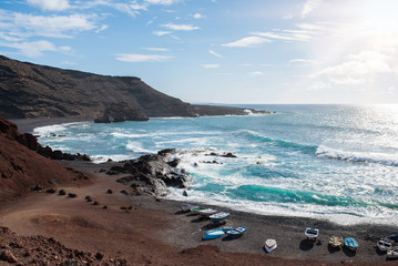 beautiful coastal landscape near El Golfo, Lanzarote against troubled blue ocean and clear sky