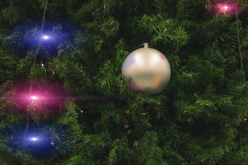 Christmas tree needle branches background with toy ball and garland blue and purple illumination winter holidays happy emotion concept background picture  