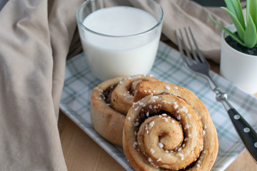 cinnamon rolls with glass of milk on the table