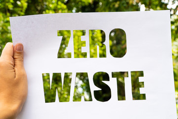 zero waste paper text with green grass on white background. lettering. ecology concept