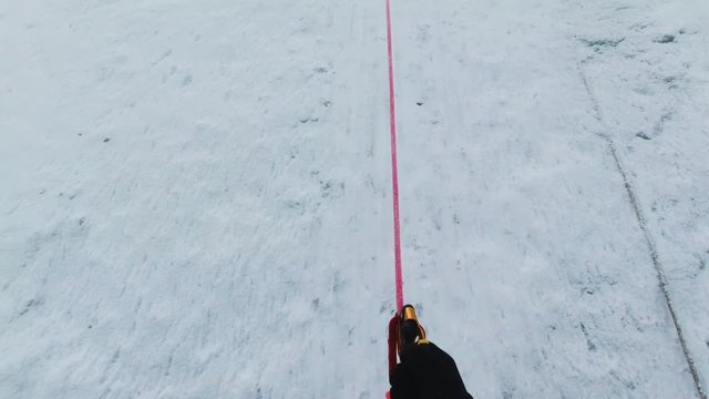 Mountaineer Man in Crampons is Using Jumar on Fixed Rope to Ascend Mountain. Fpv View