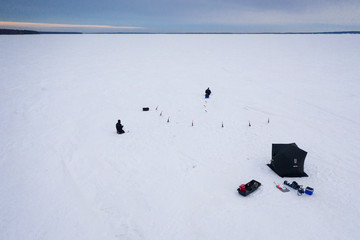 winter fishing on frozen lake