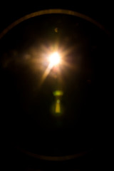 abstract lens flare red light over black background