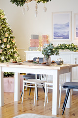 Christmas table in the kitchen with a festive Christmas tree decorated with toys. New Year's cuisine.