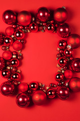 Christmas composition. Christmas red decorations on red background. Flat lay. Christmas and happy new year concept for Christmas promotion banner