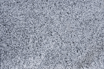 Closeup of grey polished granite texture background.