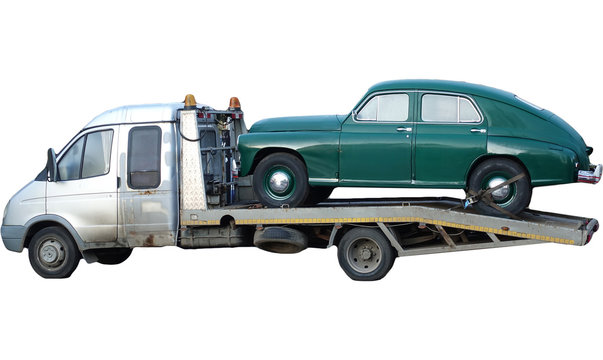 Russian tow truck transports a vintage passenger car of the Stalin era.