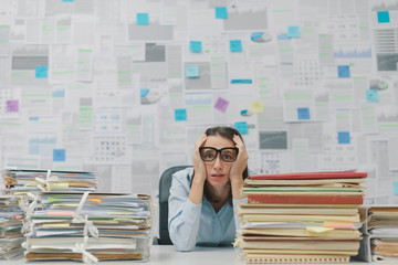 Stressed businesswoman overloaded with work