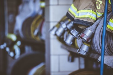 Closeup shot of firefighters clothes and hose with a blurred background