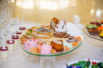 Various fruits, desserts, pastries on the holiday table. New year or Christmas.