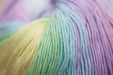 Abstract of skein of mixed pastel colored acrylic threads in a roll with selective focus