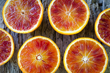 Sliced blood oranges on wooden board