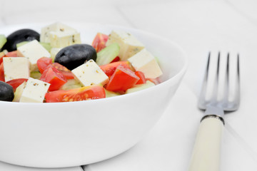 Vegetable salad in a bowl on a wood table