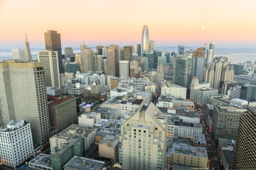 Sunset and moonrise over San Francisco Downtown. Taken from an elevated point above Union Square.
