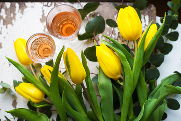 yellow tulips with glasses of rose wine