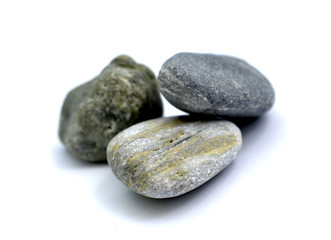 Fototapeta na wymiar stone from the beach pictured in studio on white background