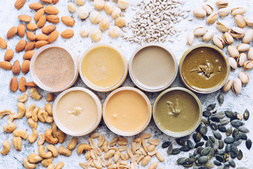 Obraz na płótnie Canvas Nuts and seeds butter in glass jars