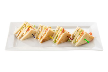 Club sandwiches with chicken, bacon, cheese and pickle isolated on white background