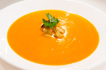 Pumpkin and carrot soup in a bowl