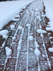 A Snow Splattered Brick Walkway