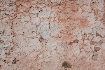 Very old and cracked wall textured background with earth, orange, brown and white colors