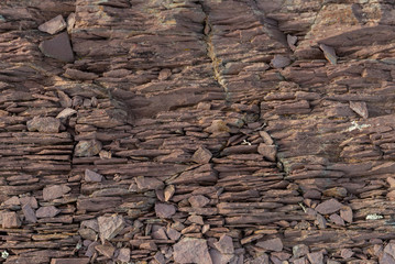 Textured background of pieces of slate stone with gray and brown colors