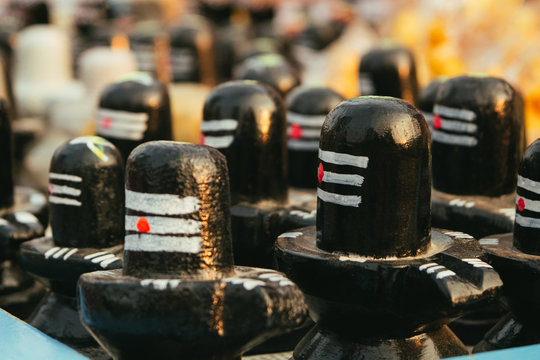 Group of shiva lingams at indian market tray in Hampi, summer evening