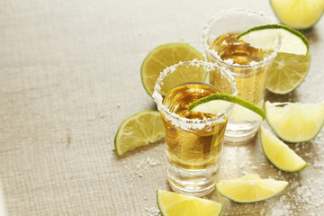Tequila shots with sliced lime	