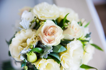 beautiful bridal bouquet lying on sofa