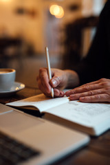 Male designer sketching web design into diary at office