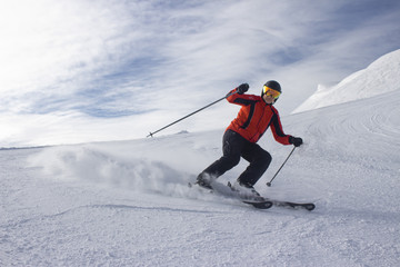 Fototapeta na wymiar Male skier on slope in mountains sunny weather