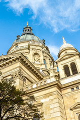 Fototapeta na wymiar Exterior facade of St. Stephen's Basilica in Budapest, Hungary on vertical photo with blue sky above. Roman Catholic basilica built in neoclassical style. Historical architecture in Hungarian capital