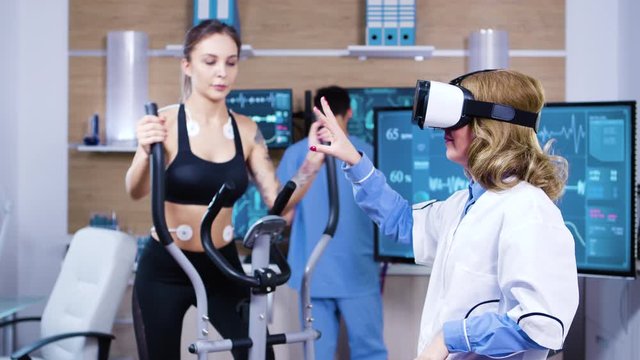 Female scientist with virtual reality goggles for sport measuring