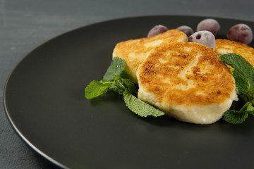Cottage cheese pancakes on a dark plate