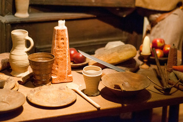 Old pottery on the table. Table set in medieval style. Lunch time.