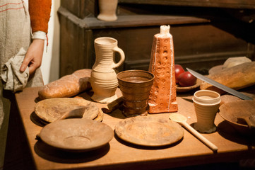Old pottery on the table. Table set in medieval style. Lunch time.