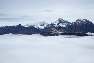 Naklejka na ściany i meble Mont Blanc. Aerial view of the Alps surrounded by clouds.