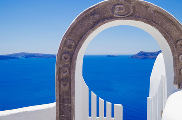 Typical white and colored Greek houses and architecture with amazing views and terraces in Oia on...
