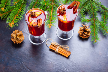 Mulled wine in glass mug with spices. Glasses of mulled wine with cinnamon, anise and fir tree...