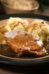 Braised pork neck in own sauce. Shallow depth of field.
